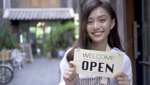 Wallpaper Mural Happy of beautiful Asian businesswoman on front door holding open sign in modern cafe standing alone smiling and looking at camera. People and start-up concept.
 Torontodigital.ca