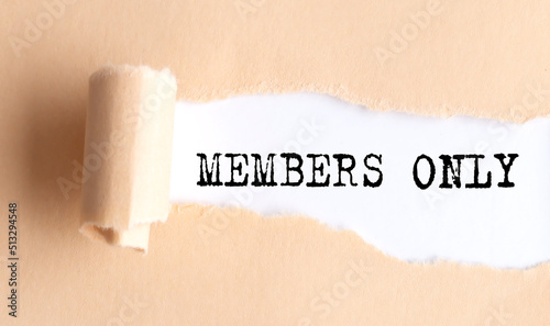 The text MEMBERS ONLY appears on torn paper on white background.