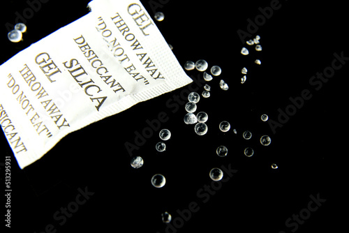 Open packet of Silica Gel Beads on black background