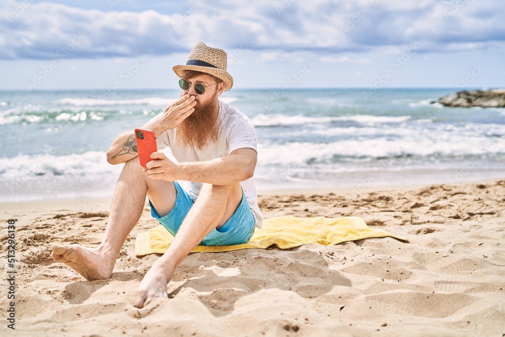 custom made wallpaper toronto digitalYoung redhead man making selfie by the smartphone sitting on the towel at the beach.