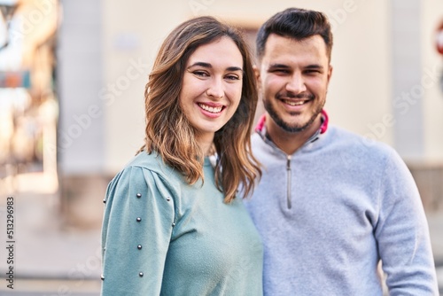 Man and woman smiling confident standing together at street