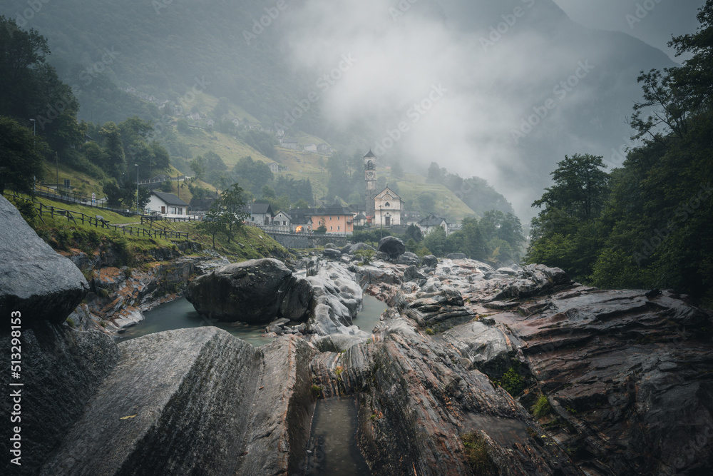 Traditional stone houses and a church in picturesque Lavertezzo village, Ticino, Switzerland at Ponte dei Salti with waterfall, Verzasca Valley, Ticino Canton