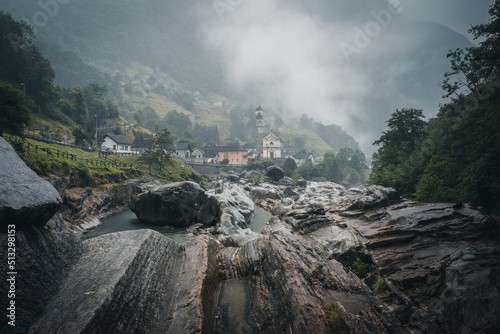 Traditional stone houses and a church in picturesque Lavertezzo village, Ticino, Switzerland at Ponte dei Salti with waterfall, Verzasca Valley, Ticino Canton