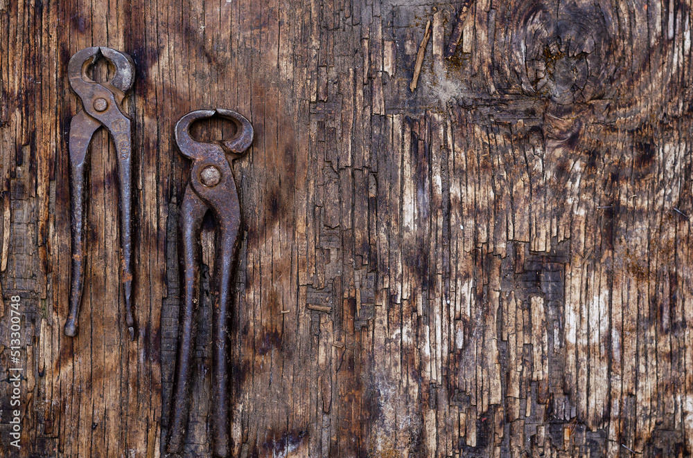 Hand Tools. Old, rusty pincers on Dark Wooden Background. Hand Tools. Old, rusty pincers on Dark Wooden Background.