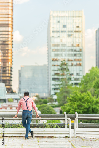 Back of a man looking the urban landscape from viewpoint