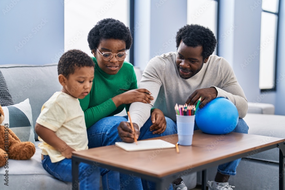 African american family drawing on notebook at home