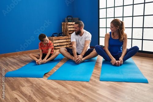 Family smiling confident stretching at sport center