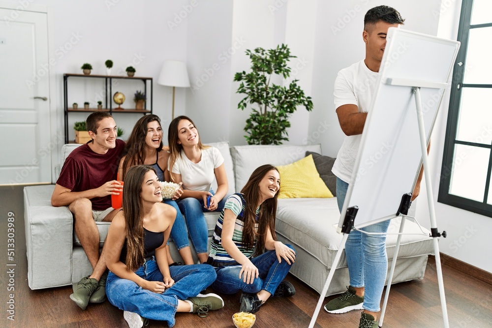 Group of young hispanic friends smiling happy playing draw game at home. Group of young hispanic friends smiling happy playing draw game at home.