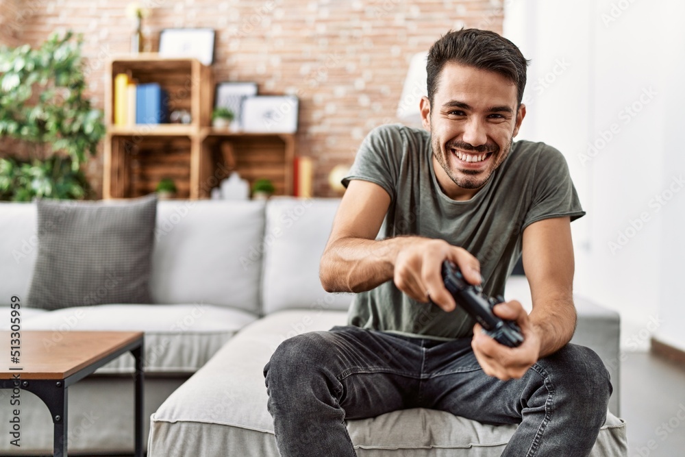 Young hispanic man smiling confident playing video game at home Young hispanic man smiling confident playing video game at home