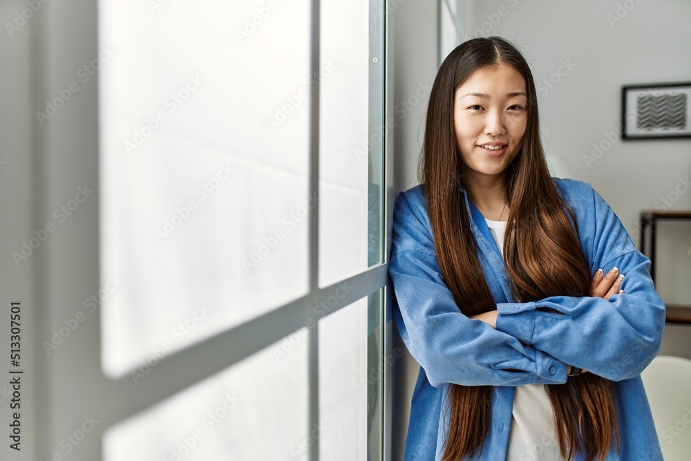 Young chinese girl smiling happy standing with arms crossed gesture at home. Young chinese girl smiling happy standing with arms crossed gesture at home.