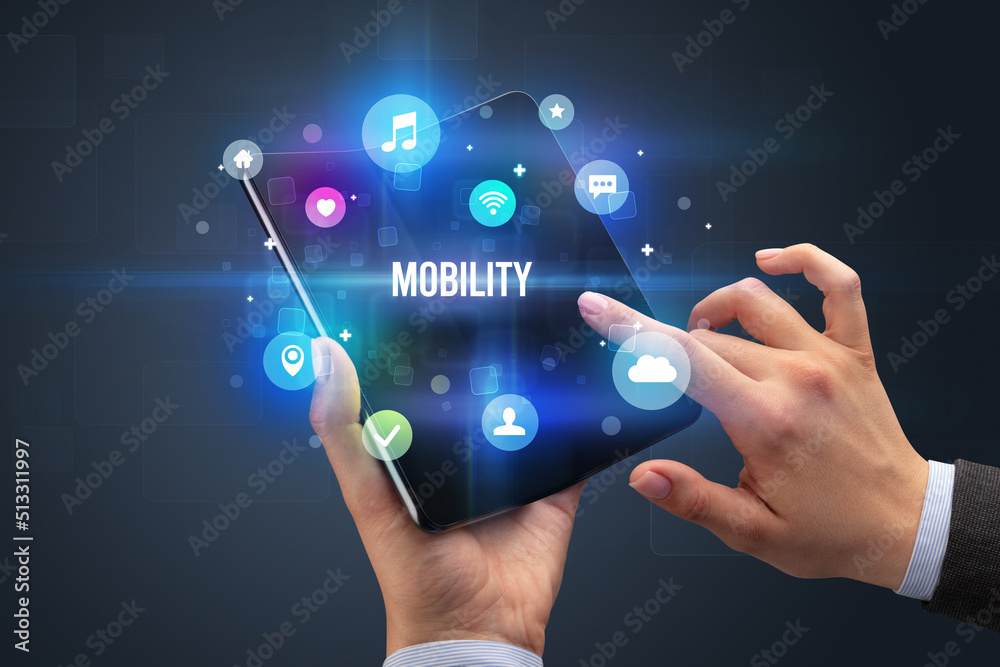 Businessman holding a foldable smartphone Businessman holding a foldable smartphone