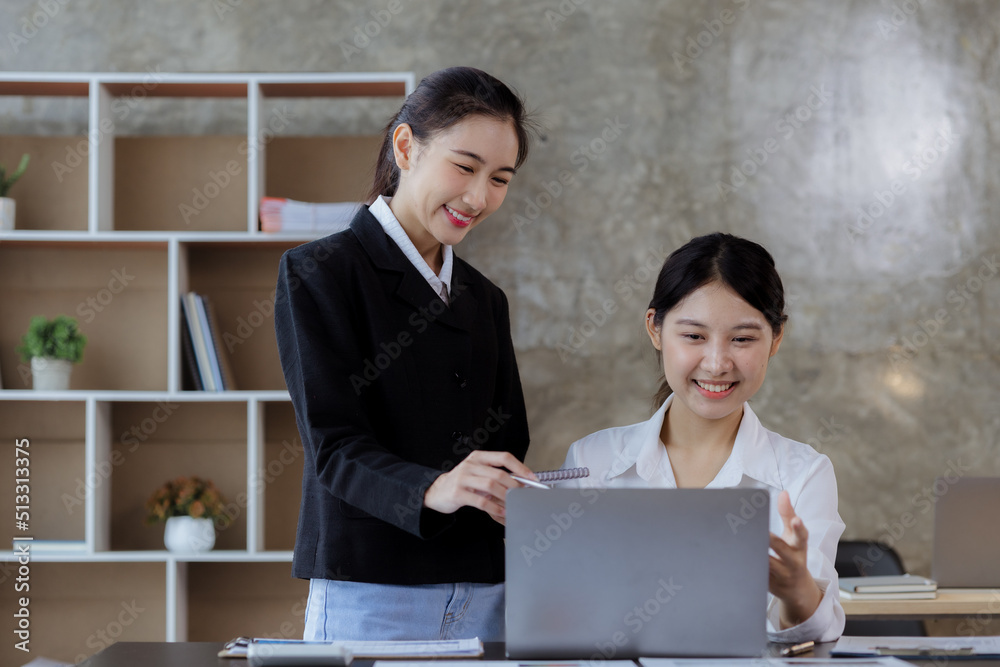 Atmosphere in the office of a startup company, two female employees are discussing, brainstorming ideas to working on summaries and marketing plans to increase sales and prepare reports to managers. Atmosphere in the office of a startup company, two female employees are discussing, brainstorming ideas to working on summaries and marketing plans to increase sales and prepare reports to managers.