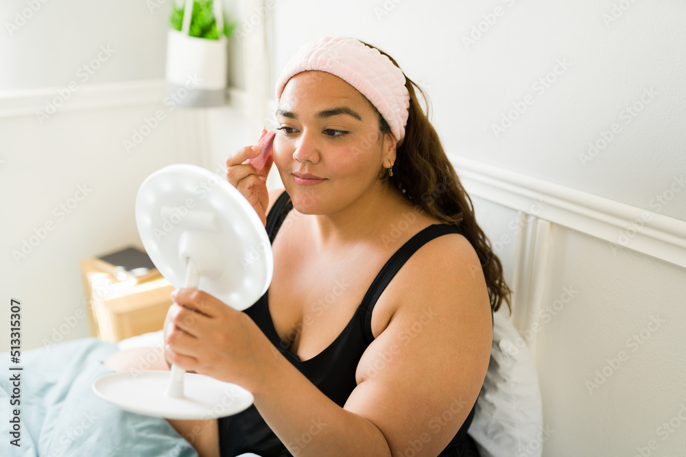 Attractive plus size woman cleaning her face Attractive plus size woman cleaning her face