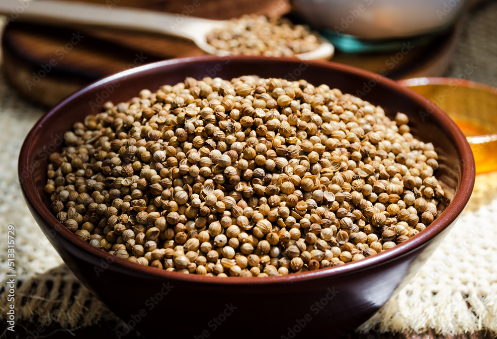 Coriander grains in a ceramic bowl. Coriander grains in a ceramic bowl.