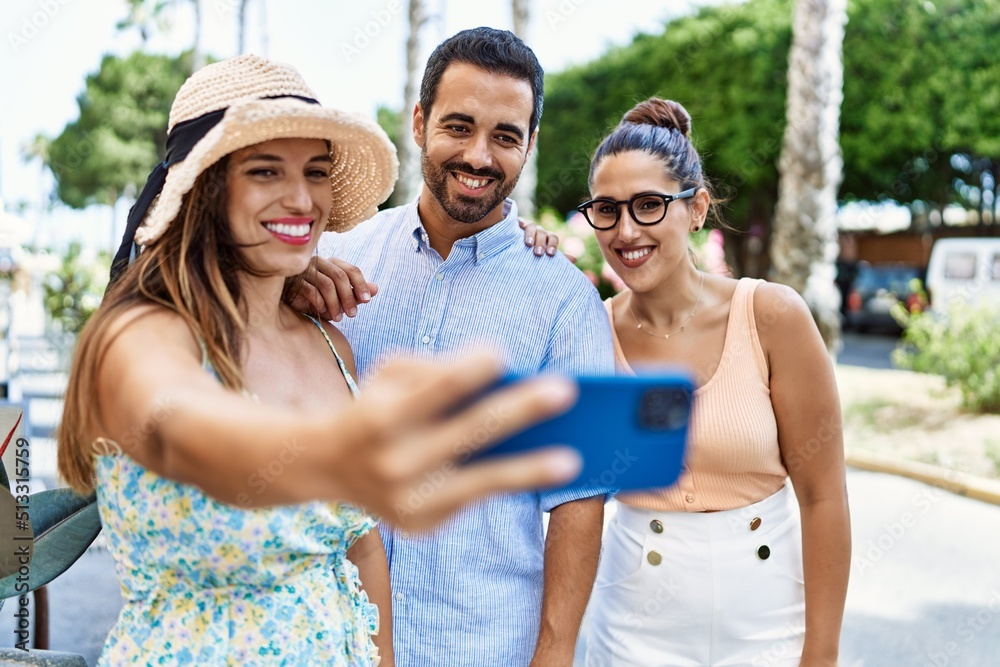 Three hispanic friends smiling happy make selfie by the smartphone at the city. Three hispanic friends smiling happy make selfie by the smartphone at the city.