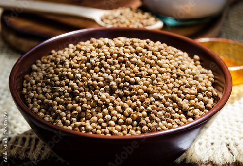 Coriander grains in a ceramic bowl.