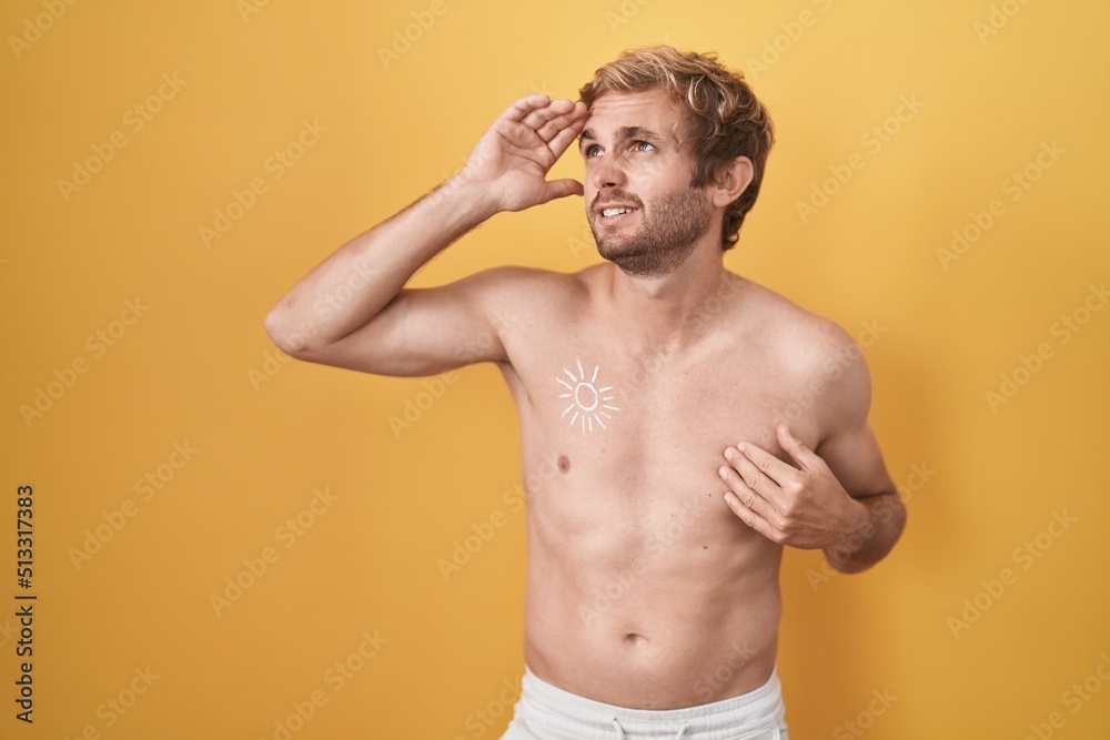 Fototapeta premium Caucasian man standing shirtless wearing sun screen touching forehead for illness and fever, flu and cold, virus sick