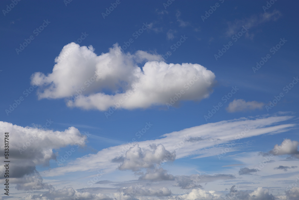 Dramatic blue clear summer sky background, white fluffy cumulus cloud over sea of cirrus clouds Dramatic blue clear summer sky background, white fluffy cumulus cloud over sea of cirrus clouds