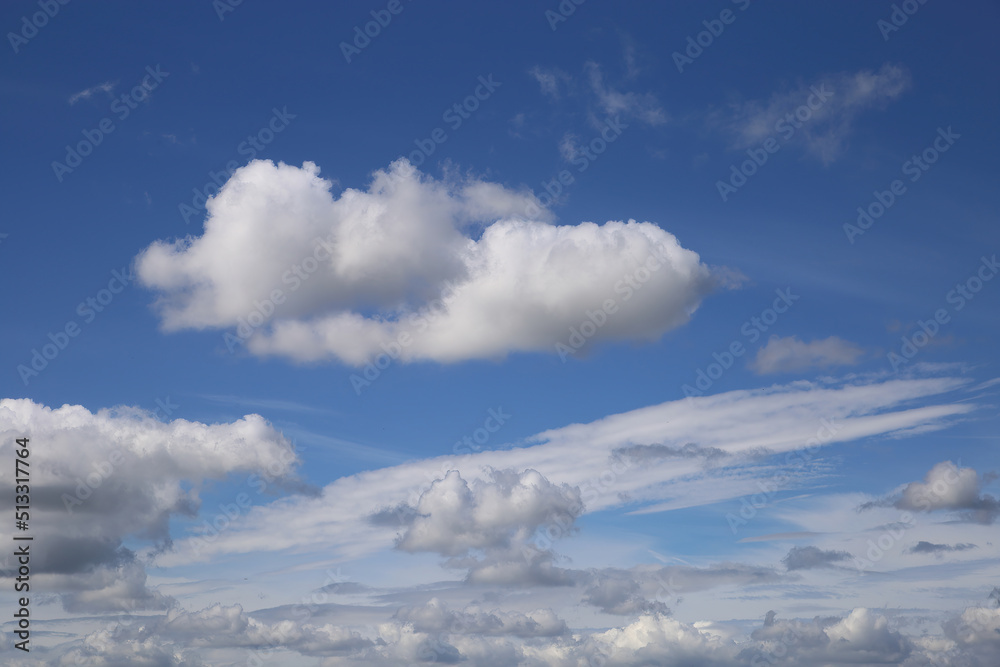 Dramatic blue clear summer sky background, white fluffy cumulus cloud over sea of cirrus clouds Dramatic blue clear summer sky background, white fluffy cumulus cloud over sea of cirrus clouds