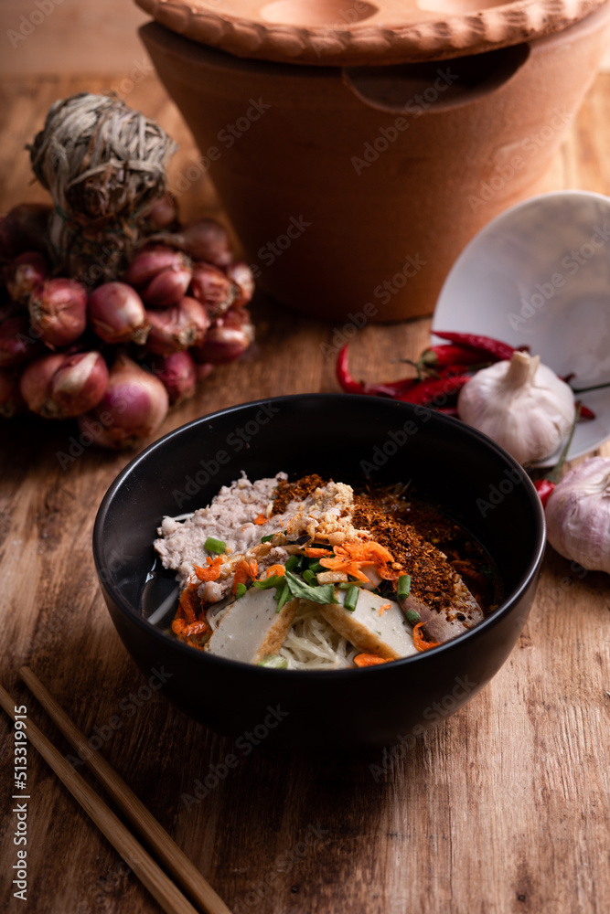 Thai Noodle , Bowl of noodles with spices on wooden background, Thai noodles soup, Table top view Thai Noodle , Bowl of noodles with spices on wooden background, Thai noodles soup, Table top view