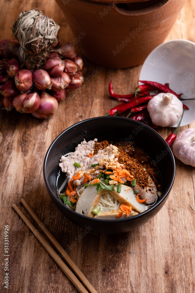 Thai Noodle , Bowl of noodles with spices on wooden background, Thai noodles soup, Table top view Thai Noodle , Bowl of noodles with spices on wooden background, Thai noodles soup, Table top view