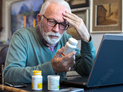 Canvas Print Senior ill man taking pills from the bottle at home