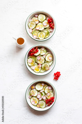 Cucumber and radish salad decorated with dill and red currants