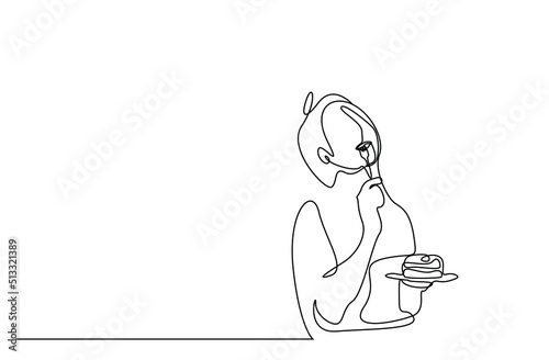 a young woman eats a slice of cake with a fork and is happy with the taste