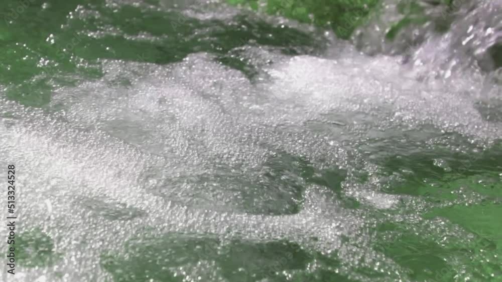 White water with foam and bubbles. Natural water flowing between rocks and creating white foam. White water with foam and bubbles. Natural water flowing between rocks and creating white foam.