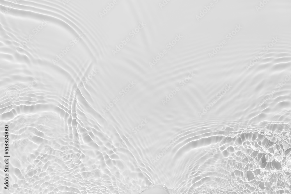 Waves on transparent water surface, gray abstract background.