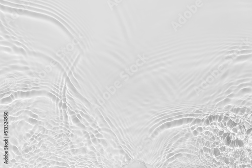 Waves on transparent water surface, gray abstract background.