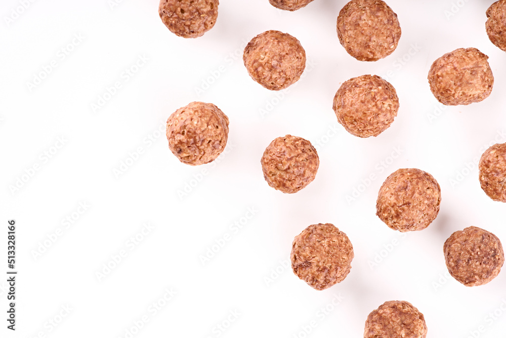 Variety of cold cereals, quick breakfast for kids overhead shot. Quick breakfast. Chocolate balls isolated on a white background. Rings isolated on a white background. Variety of cold cereals, quick breakfast for kids overhead shot. Quick breakfast. Chocolate balls isolated on a white background. Rings isolated on a white background.