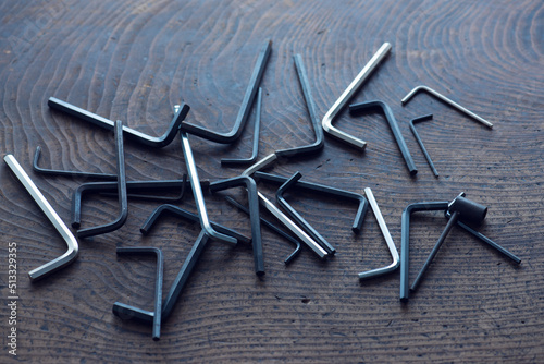 Finding the right size. Many Allen wrench (also known as Hex key or Allen key ) placed on a old wooden table.