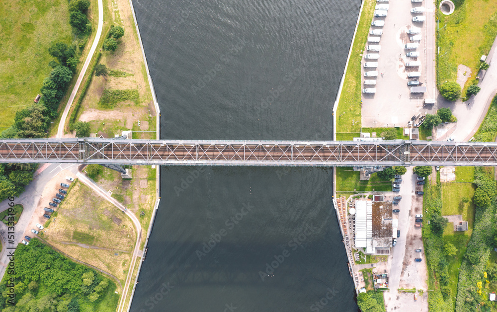 Rendsburg (Schleswig-Holstein, Germany) High Bridge (Rendsburger Hochbrücke) railway viaduct (Neumünster–Flensburg line) with Schwebefähre transporter bridge over Kiel Canal