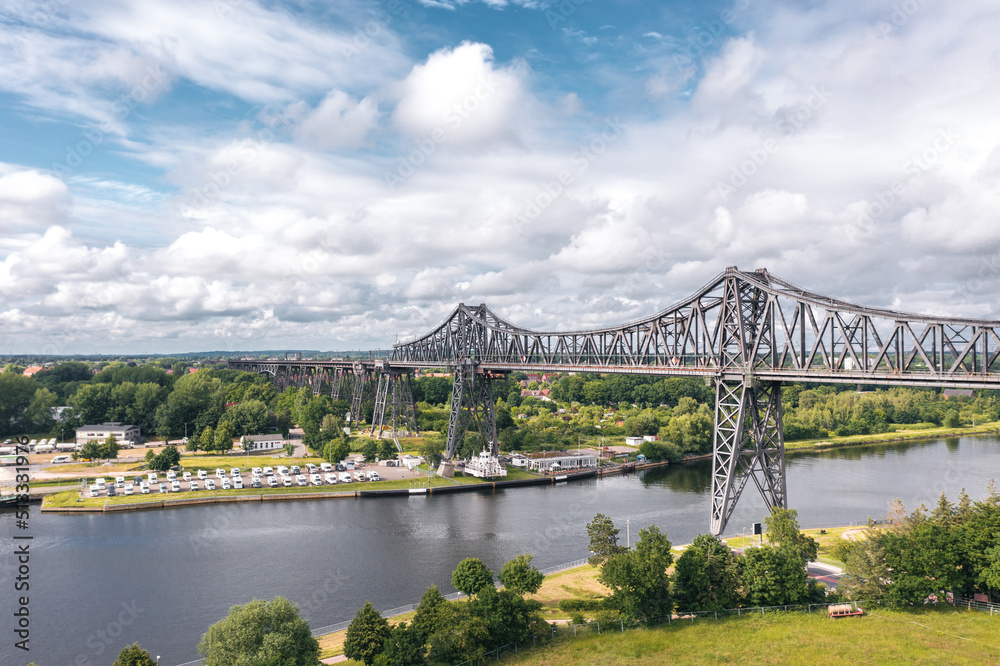 Rendsburg (Schleswig-Holstein, Germany) High Bridge (Rendsburger Hochbrücke) railway viaduct (Neumünster–Flensburg line) with Schwebefähre transporter bridge over Kiel Canal