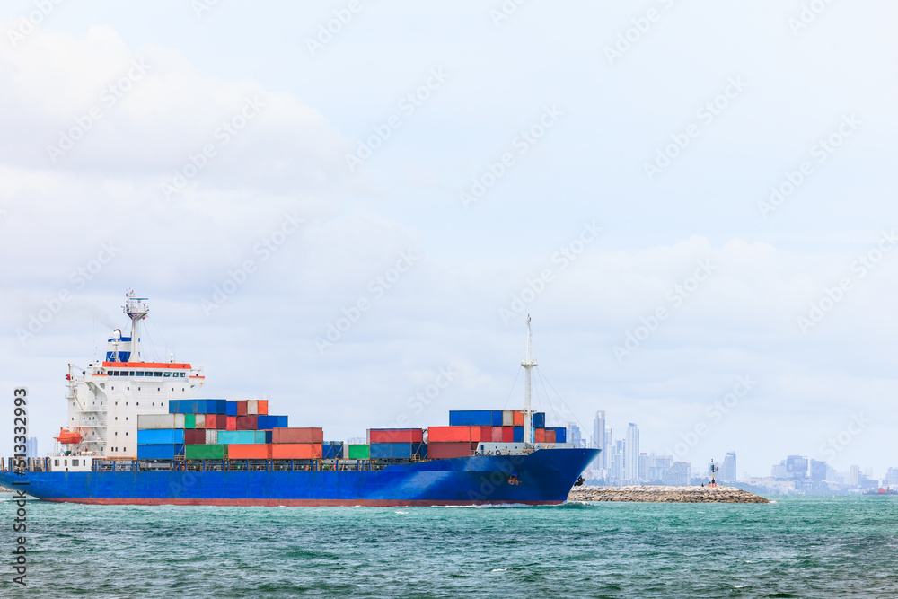 Fototapeta premium container cargo ship sailing in green sea to transport of goods import export internationally or worldwide as business and industrial transport and marine services in open sea cloud sky background,