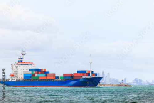 container cargo ship sailing in green sea to transport of goods import export internationally or worldwide as business and industrial transport and marine services in open sea cloud sky background,