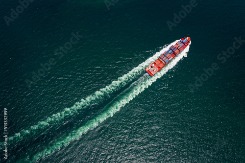container cargo ship sailing full speed in pacific ocean to transport goods import export internationally or worldwide as business and industrial transport and marine services open sea © SHUTTER DIN