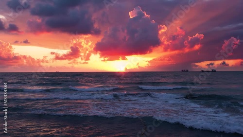 Amazing sunset over ocean. Slow motion aerial view of the ocean. Breathtaking clouds after storm.