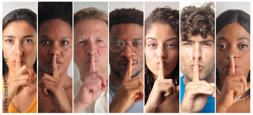 group of people with silence gesture photo