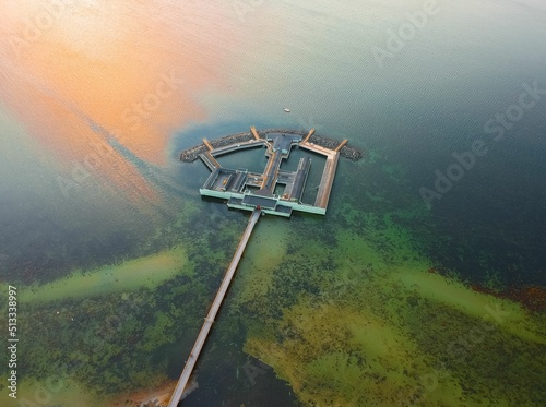 Aerial shot of the Ribersborgs Kallbadhus open-air bath in the middle of the water in Malmo, Sweden photo