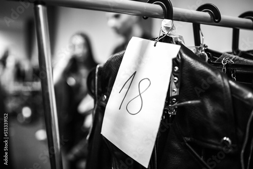 Fototapeta Fashion Show Backstage, Clothes on hangers at the backstage of a fashion show