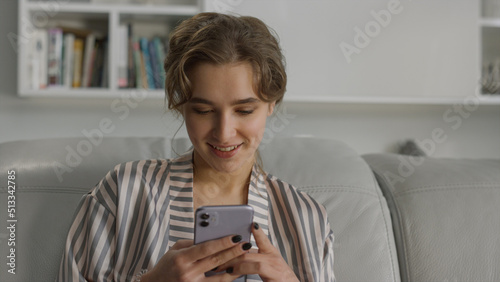 Happy girl texting message on mobile phone portrait. App user using smartphone.