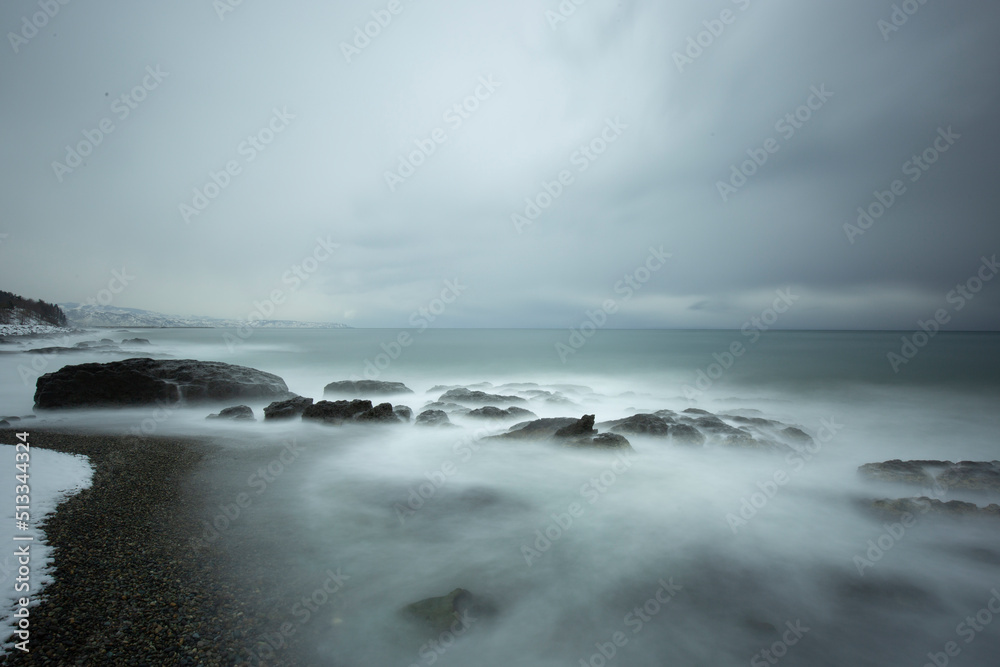 LONG EXPOSURE ON THE BEACH IN A BLACK SEA WAVY AND COLD WINTER DAY