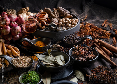 Various Thai and Chinese herbs in ceramic bowl on a dark background. Herbal and Spices Oriental marketplace. © k-02