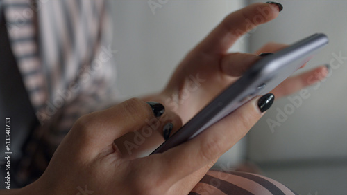 Gadget user holding smartphone in hands closeup. Girl checking social media