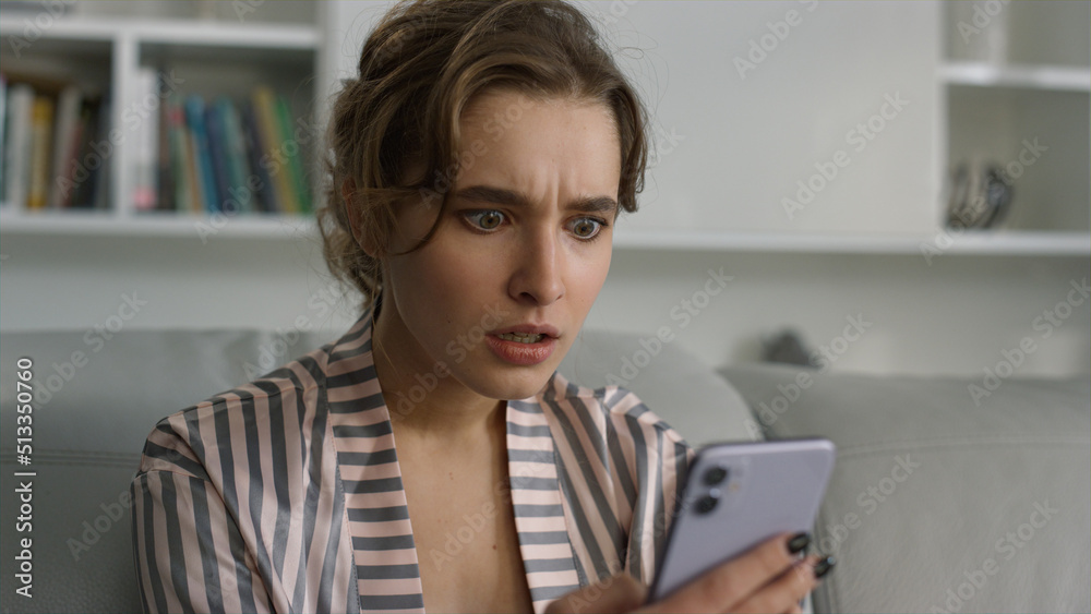 Shocked woman getting bank receipt closeup. Upset girl checking social media Shocked woman getting bank receipt closeup. Upset girl checking social media
