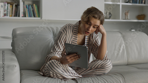 Ill businesswoman working home online. Tired lady having video call on tablet.