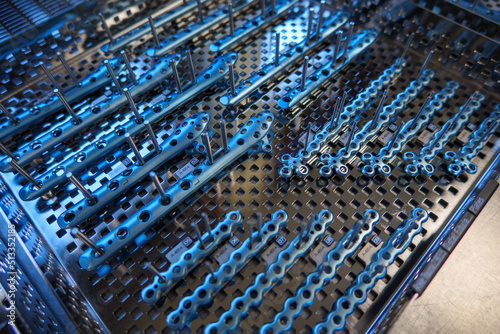 some titanium plates and instrument for ankle surgery are placed on an instrument tray