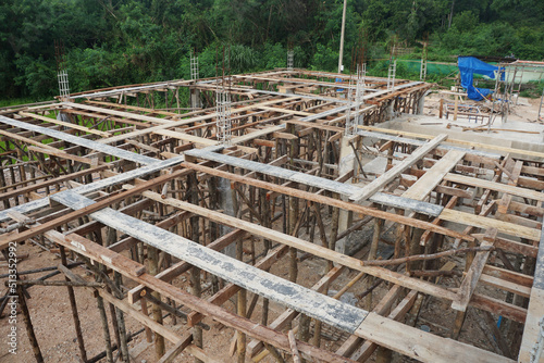 Preparation of scaffolding for assembling the second floor concrete beam formwork on construction site.